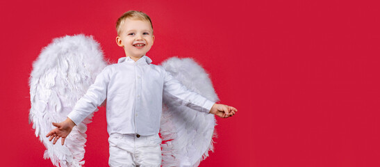 Obraz premium Angel kid banner, isolated studio background. Portrait of innocent angel looking it with love.