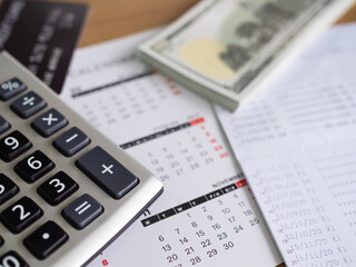 Calculator with Calendar,Money,Book Bank Papter business on Table in Office,Plan Investment Growth Income Finance,Accounting Currency Banking Saving Cash,Deposit Tax Interest Save.