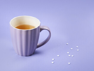 A cup of tea with sweetener.