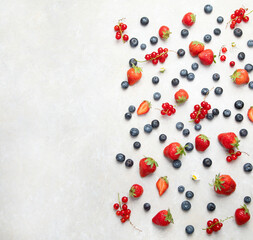 Various fresh berries on neutral background.