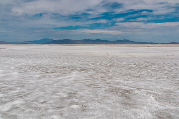 Scenic view of Bonneville Salt Flats in western Utah with Silver Island Mountains peaks in the background, Wendover, USA, America. Densely packed salt pan and natural landscape near Salt Lake City