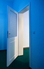 blue open room door with a view of an empty room,scary,