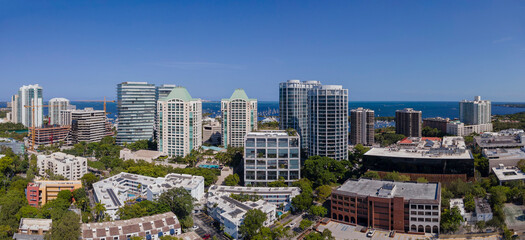 Fototapeta na wymiar Aerial view of Miami Florida city skyline with modern buildings against sky. Beautiful landscape of downtown homes and skyscrapers with ocean view in the background.