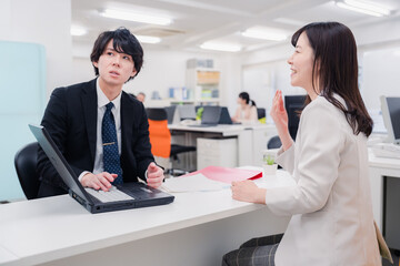 窓口で対応する男性スタッフ