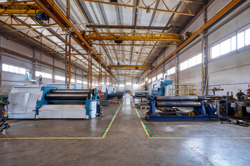 Bending rolls installed in metal sheet processing workshop