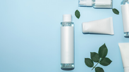 Facial cosmetics, skin care product, natural cosmetics, flat image on blue background. Facial care and beauty