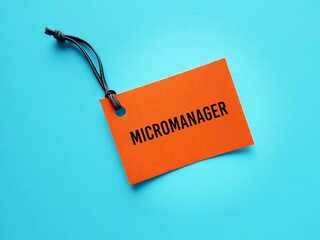 Red tag on blue background with text written MICROMANAGER refer to a boss or manager who gives...