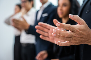 Close up hand of young businessman and businesswoman clapping together