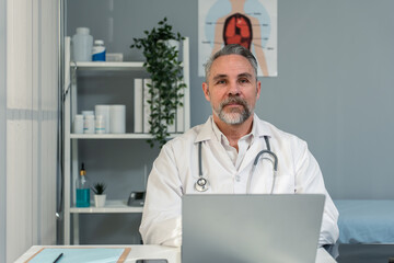 Portrait of Caucasian male doctor talking virtual online with patient. 