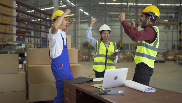 Teamwork group of Asian man worker working in large warehouse retail store industry factory. Rack of stock storage. Cargo in ecommerce and logistic concept. Depot. People lifestyle. Shipment service.