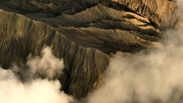 Aerial Lockdown Shot Of Smoke Emitting From Volcanic Landscape During Sunset - Java, Indonesia