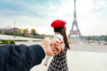 cheerful happy couple in love visiting Paris city centre and Eiffel Tower