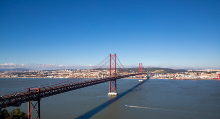 Fototapeta premium Landscape of the 25 April bridge and the city of Lisbon in the background - Portugal