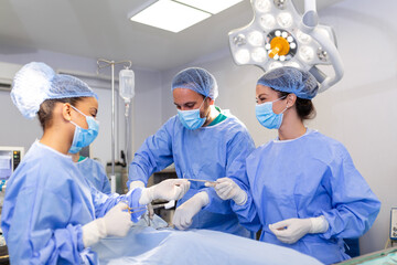 Doctor and assistant nurse operating for help patient from dangerous emergency case .Surgical instruments on the sterile table in the emergency operation room in the hospital.Health care and Medical