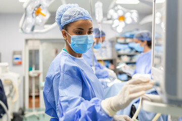 Concentrated Surgical team operating a patient in an operation theater. Well-trained...