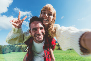 Happy couple on vacation on the italian dolomites mountains.