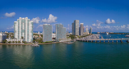 Panorama of builings and highway over Intracoastal Waterway in Miami Florida. Scenic urban skyline against a manmade inland water channel and bright blue sky on a sunny day.