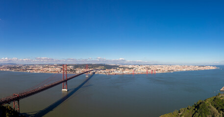 Fototapeta na wymiar Landscape of the April 25 bridge over the Tagus river and the Lisbon city in the background