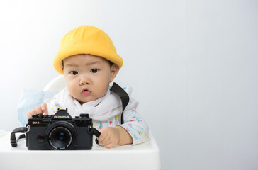 asian baby boy plays with camera on high chair,baby lovely,asia baby boy