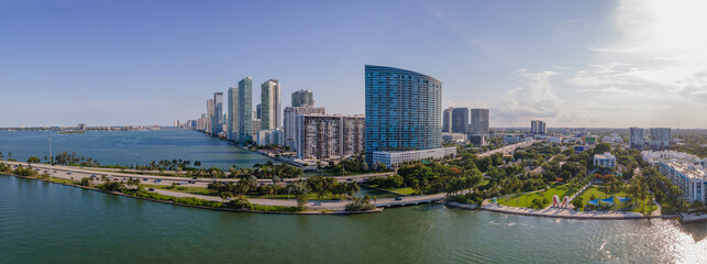 Scenic panorama of the Intracoastal Waterway and city skyline in Miami Florida. Aerial view of beautiful modern buildings, roads, and trees against a man-made inland water channel.