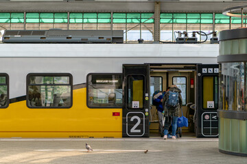 Passengers boarding polish electric regional train in Wrocław - obrazy, fototapety, plakaty
