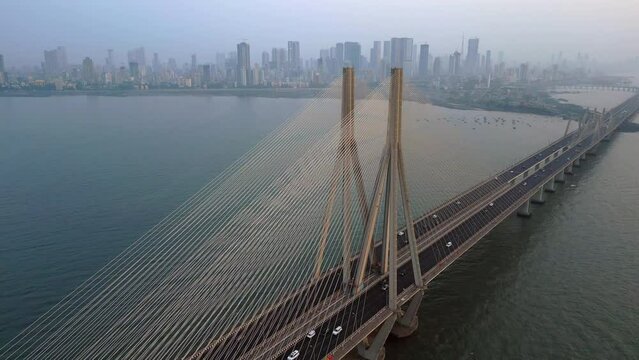 Aerial view of traffic on the Bandra Worli Sea Link cable stayed bridge with the Mumbai skyline in the background in Mumbai, Maharashtra, India.