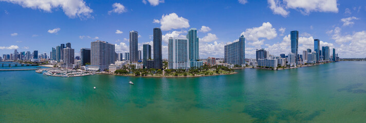 Intracoastal Waterway and Miami Beach Florida against blue sky and clouds. Beautiful scenery of inland water channel with modern buildings in Miami skyline.