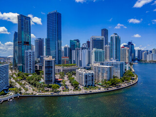 Urban landscape of buildings and the Miami South Channel in Miami Beach Florida. The hig rise condominuims and offices has a wonderful view of the lagoon and blue sky.