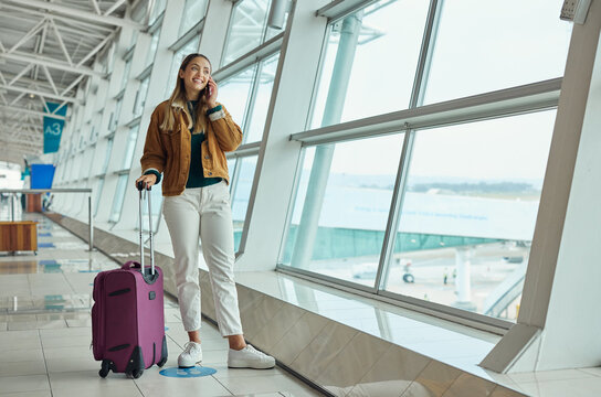Phone call, travel and woman with luggage at airport, chatting or speaking to contact in lobby. Suitcase, mobile and happy female with smartphone for networking while waiting for flight departure.