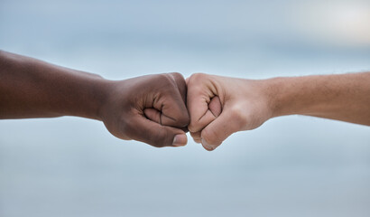 Diversity, hands and fist bump on mockup for community, trust or unity on blurred background. Hand...