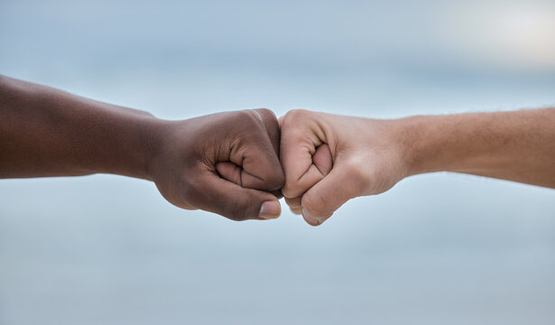 Diversity, hands and fist bump on mockup for community, trust or unity on blurred background. Hand of people bumping fists in solidarity for deal, partnership or teamwork agreement, victory or win