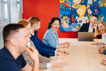Fototapeta premium The male manager holds a meeting for subordinates in the meeting room.