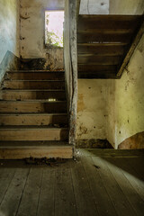 Fototapeta na wymiar Old staircase with wooden steps, of an abandoned house