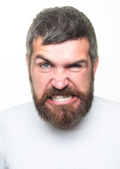 Obraz premium Man with angry expression. Angry hateful guy furious. Angry rage man face. Anger man with furious negative emotion portrait. Aggressive and mad bearded man bad behavior in studio.