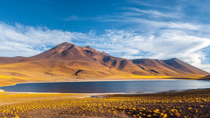 The mountain lake Laguna Miniques with volcano in the background on the high altitude plateau of the Andes in the north of Chile © Chris