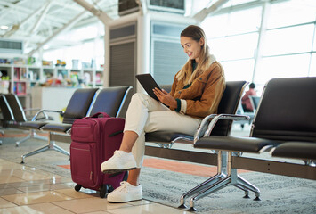 Travel, tablet and woman relax in airport lobby, social media or internet browsing. Immigration,...