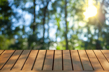 wooden table with forest bokeh background