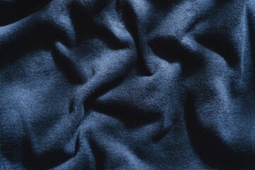 Abstract structure- wrinkles on the fabric. Textile-  simple dark background