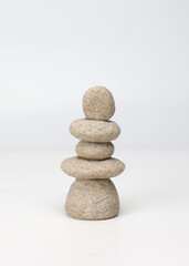 Zen stack of stones on white background