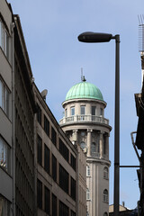 Neoclassical tower with a green dome. Architectural details of the building in Istanbul.