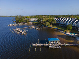 Townhouses with balconies facing the waterfront with docks in Navarre, Florida. Boat lifts and dock...