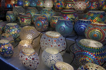 Table lamps decorated with mosaics of various colors for sale in a street market