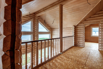 Obraz premium A two-story wooden cottage from the inside out in coniferous spruce pine green forest