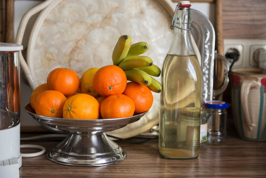 Fruit bowl with elderberry syrup on kitchen counter, Munich, Bavaria, Germany