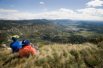 two mountain bikers looking at view, Vipava valley, Istria, Slovenia