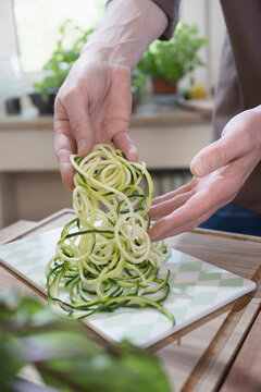 Man with fresh zucchini spaghetti