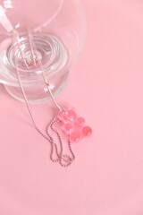 Children's  jewelry in the form of a bear on a pink background. Jewelry, costume jewelry.