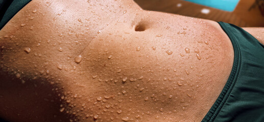wet woman's body in bikini. water drops on stomach