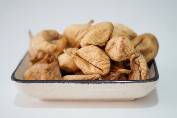 Dried figs in plate isolated on white