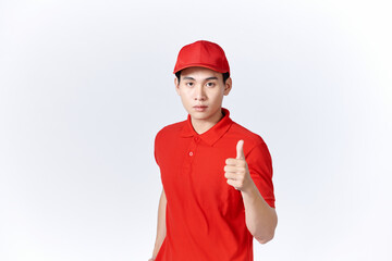 Professional delivery guy employee man in red cap T-shirt uniform workwear work as dealer courier showing thumb up like gesture isolated